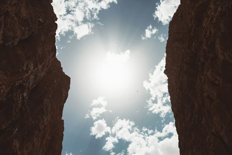 a bird flying in between two rocky outcroppings