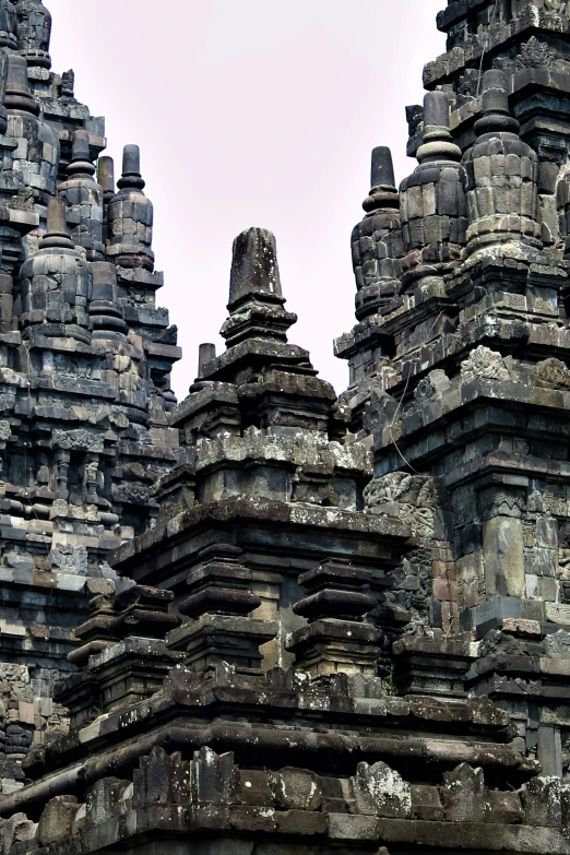 an ancient building made out of rock with carved figures on it