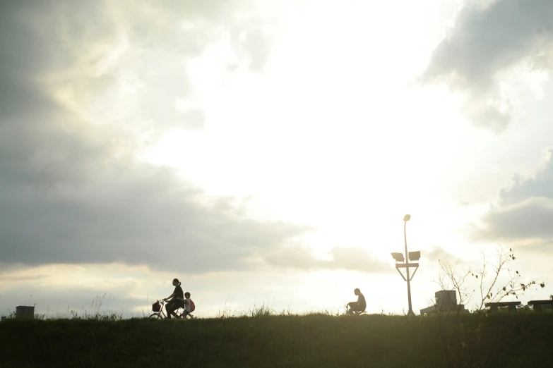 there are people riding bicycles on a hill