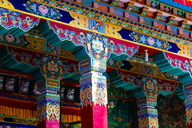 brightly colored oriental style building with two columns and decorations