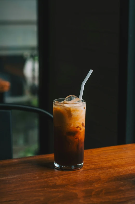 a drink sitting on top of a wooden counter