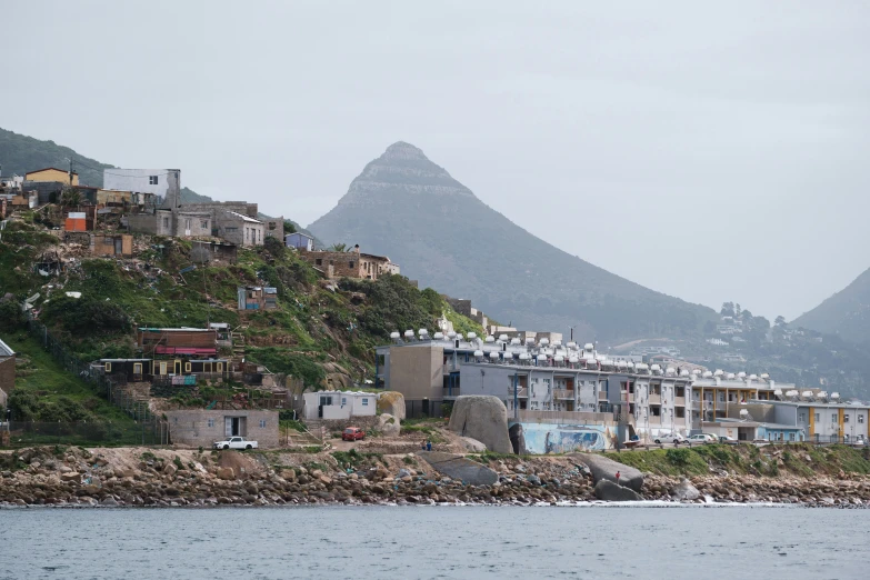 houses built high on the side of a hill on a cloudy day