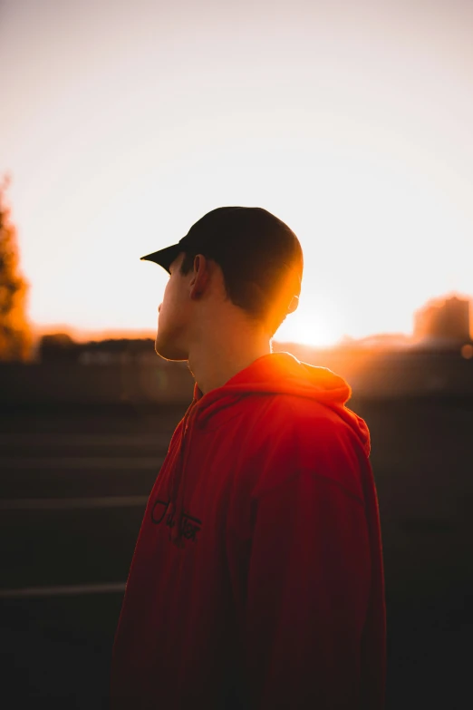 the sun is shining through a person wearing a red jacket