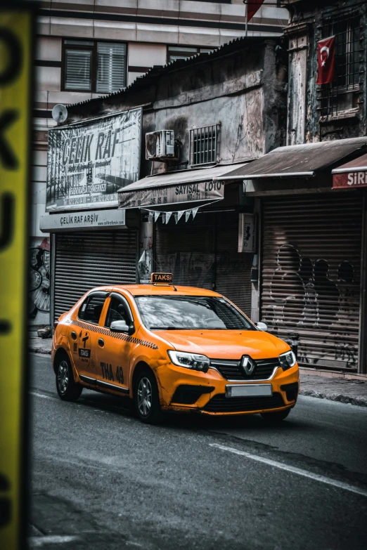 yellow taxi cab with lights and graffiti on it