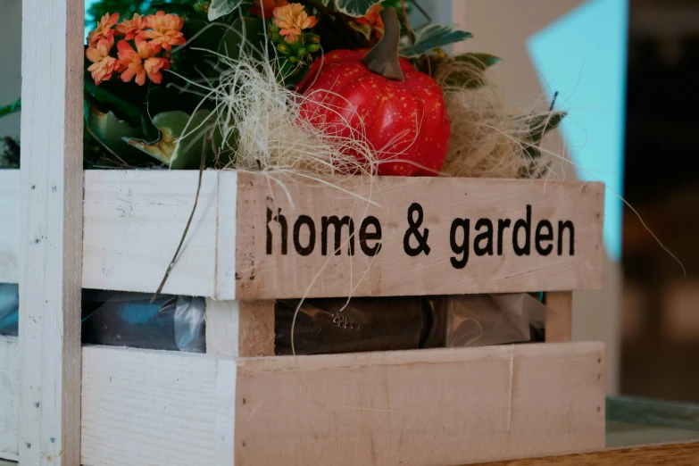 some tomatoes and flowers are in a crate