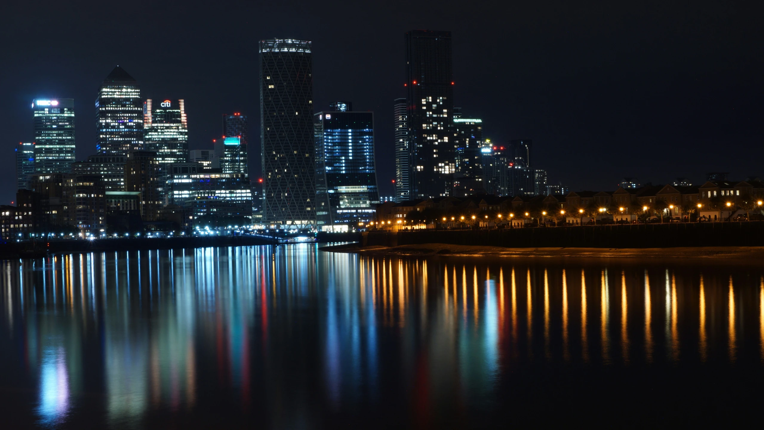 some buildings lights water lights and street lights