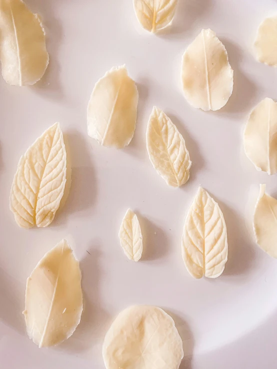 a white plate with peeled cheese cut into small pieces