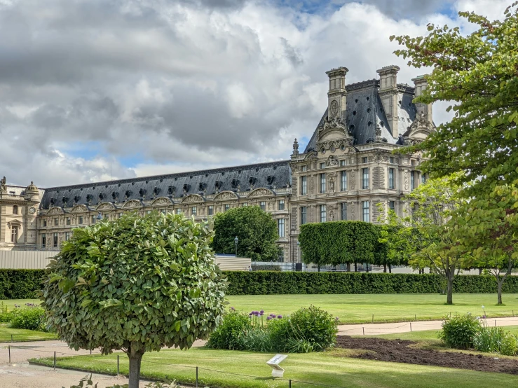 a view of the back of a building and lawn