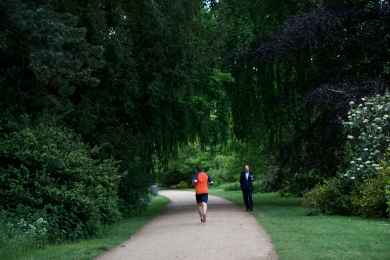 two people are jogging in a park