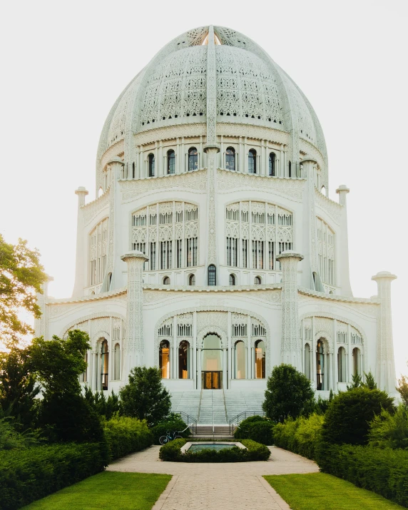 a large building sits in the middle of some green trees