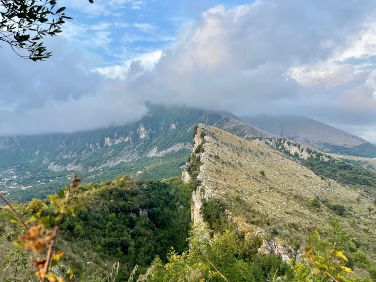 view of some hills and mountains with the sky above