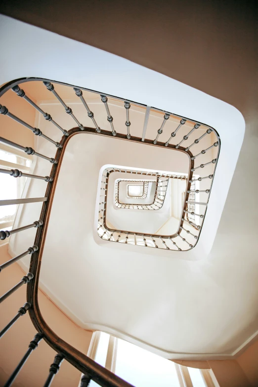 an empty spiral staircase with lots of glass