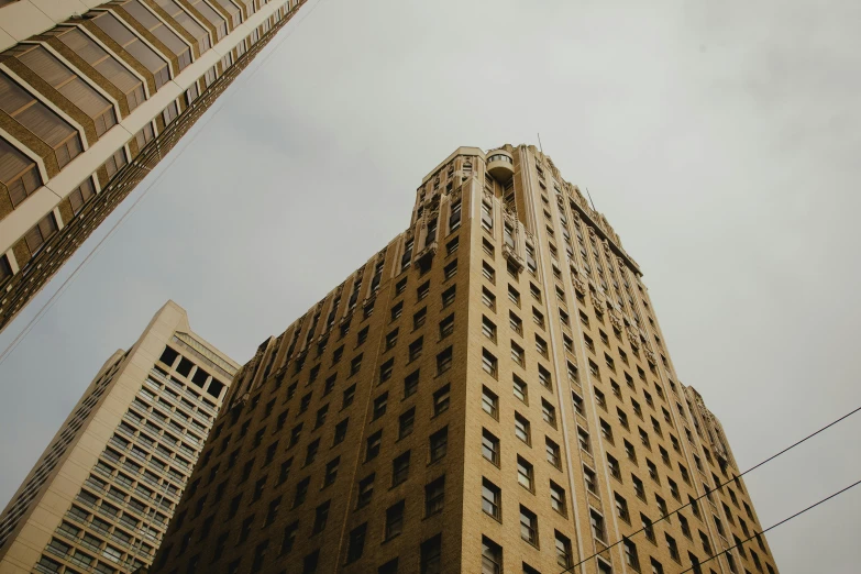 a large tower with windows standing next to two buildings