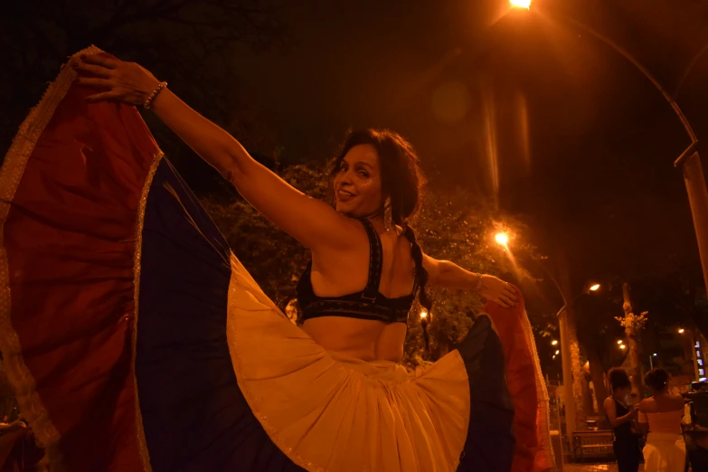 a woman in traditional costume performing on the street