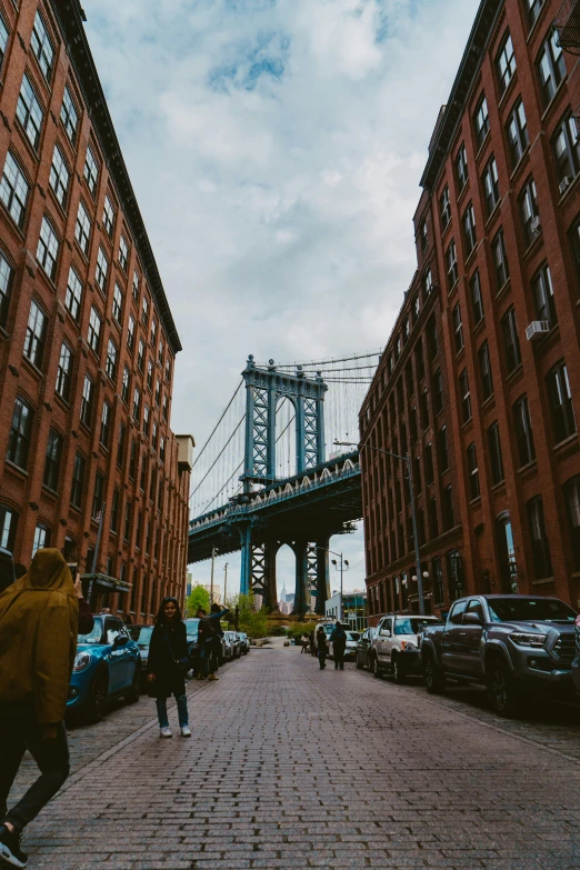 a street filled with tall red brick buildings next to tall tall buildings