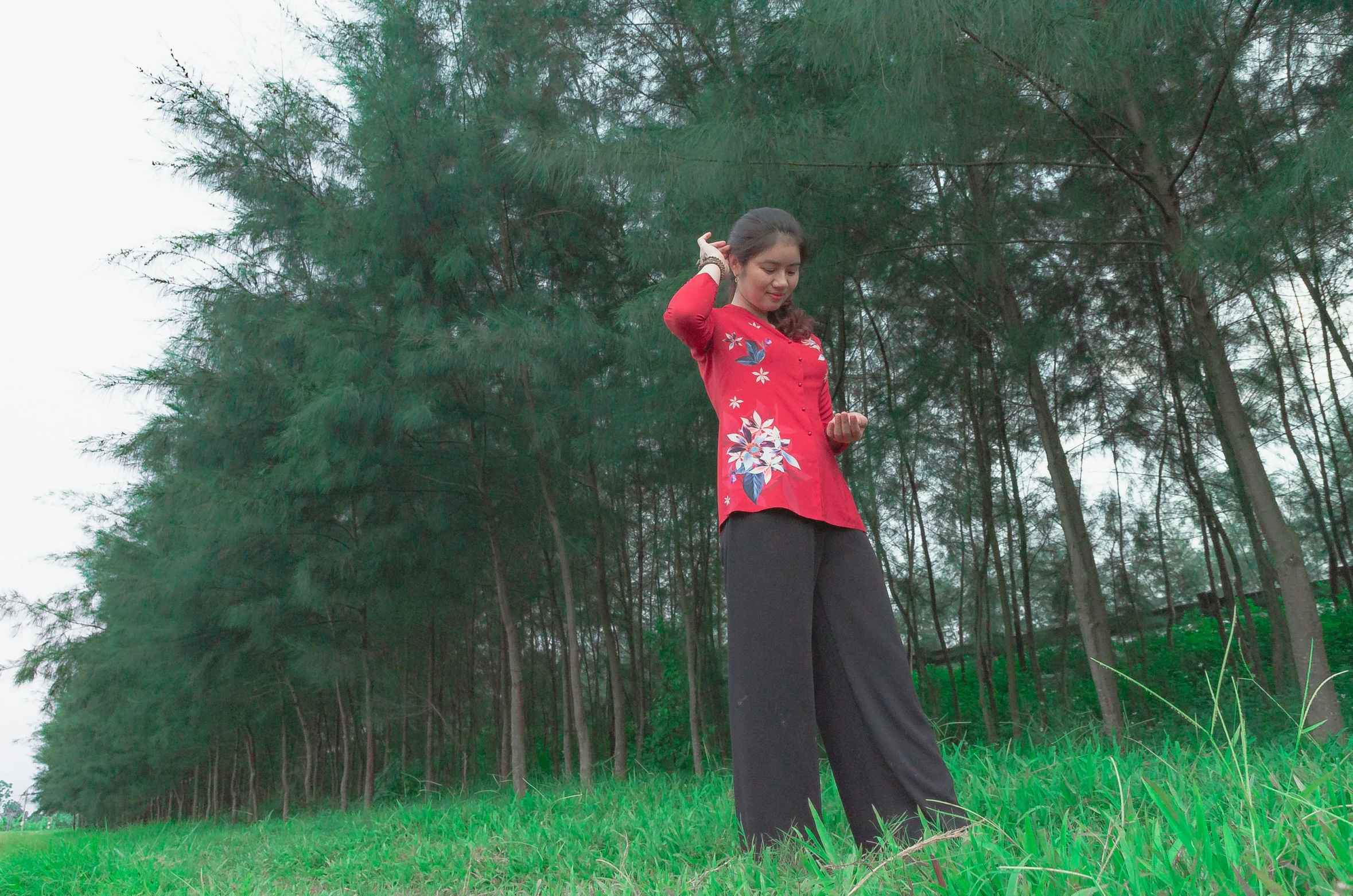 a woman wearing red posing with a kite