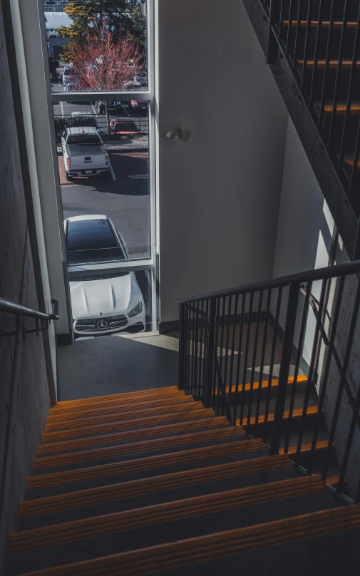 the door leading to a parking lot of parked cars