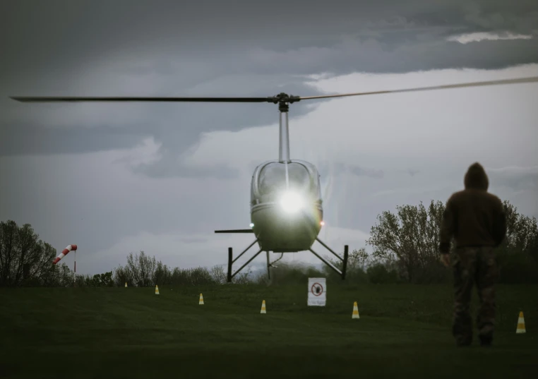 a person walking away from a helicopter in the air