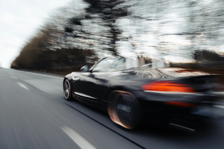 an image of car on the road that is blurry