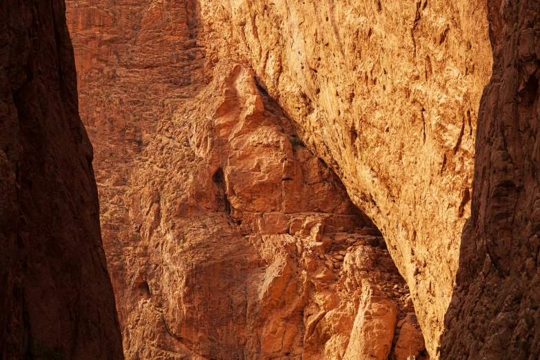 a large mountain with rocks and a lone person