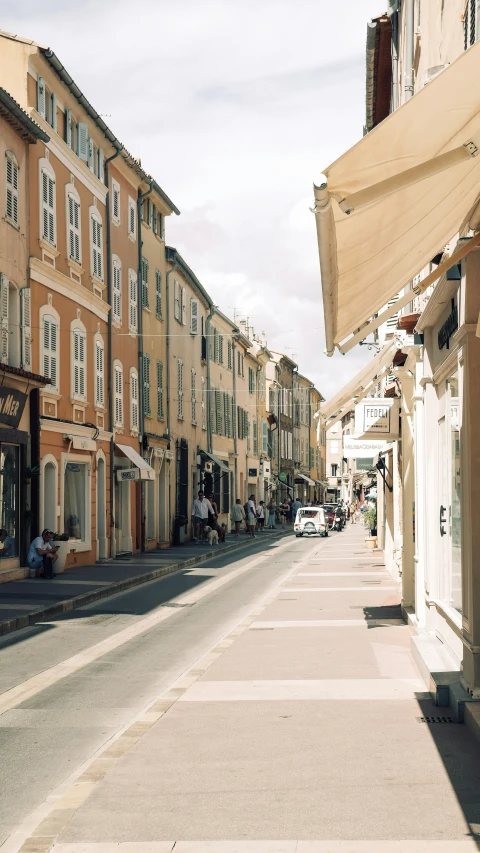 an empty street next to buildings with a clock tower