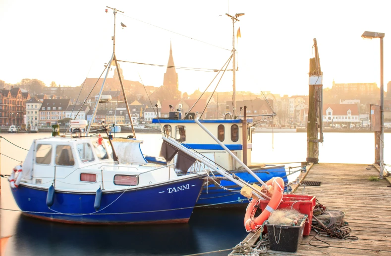 three boats sit side by side in a bay