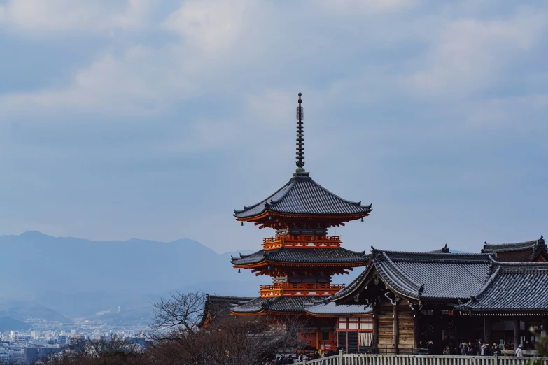 the pagoda towers are next to some trees