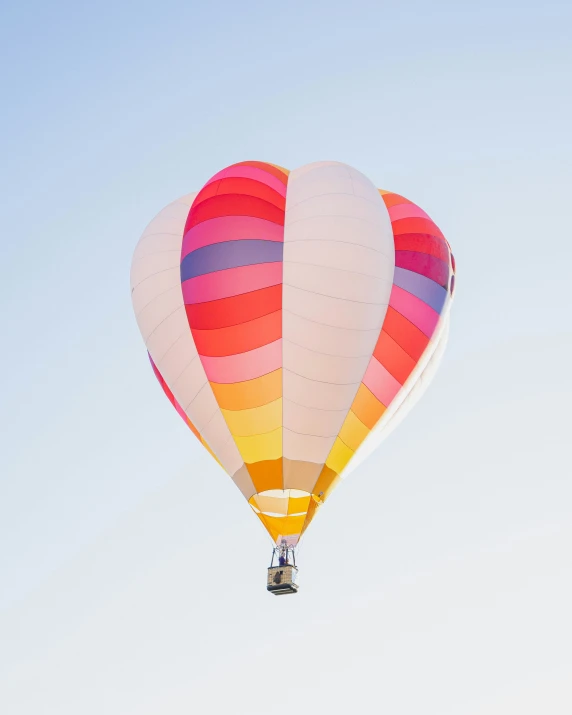 a  air balloon in the sky, with a clear sky behind it