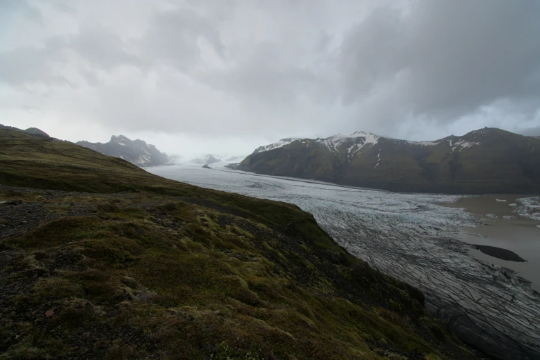 a body of water with mountains in the background