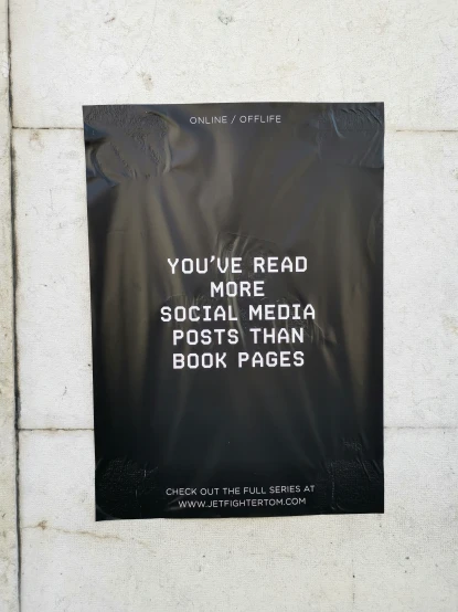 a book page posted on a building wall