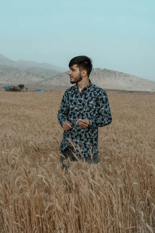 a man standing in the middle of tall grass