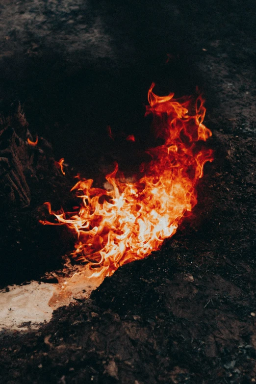 a large flame blazing on a road at night