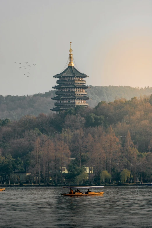 there are several boats in the water by this tower