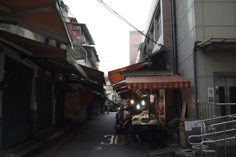 a street market is shown with people standing around