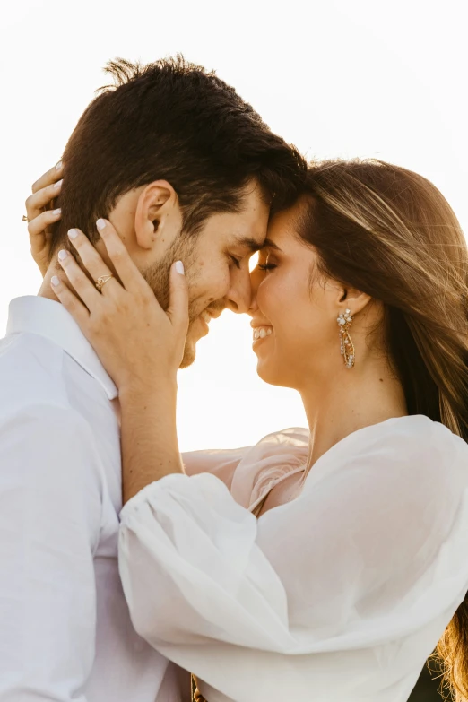 a beautiful couple kissing under a clear sky