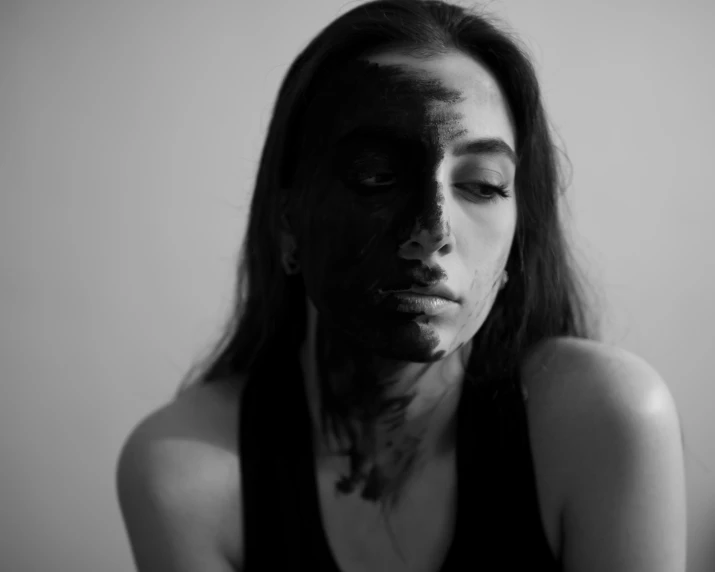 a black and white po of a woman with face makeup