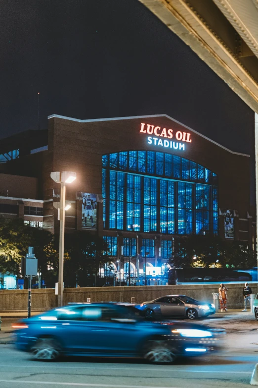 a large building sitting next to a street filled with cars