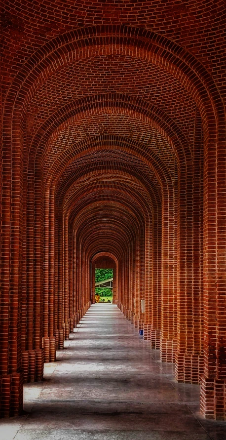 the walkway inside of the brick buildings is empty