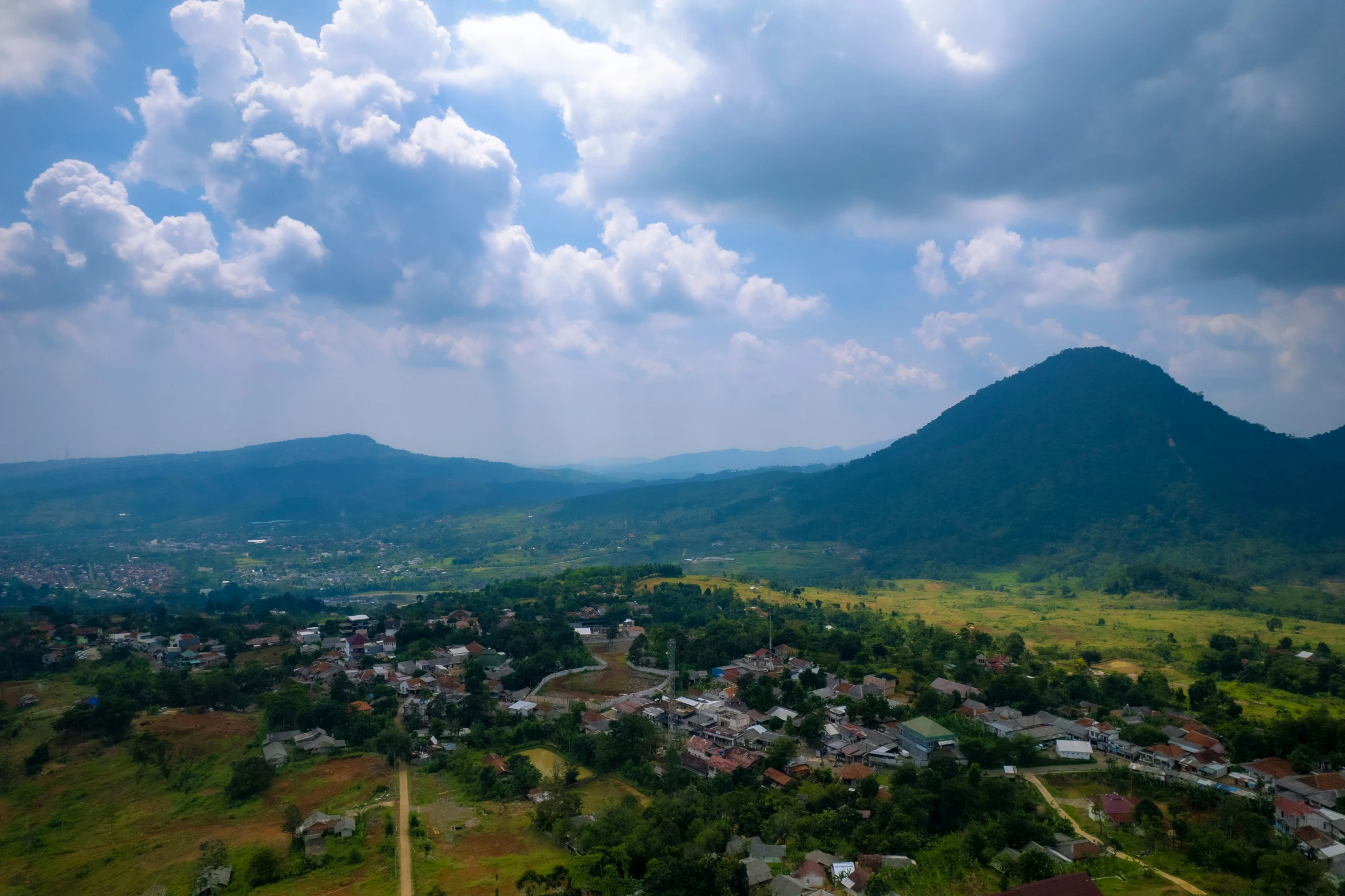 a view of a city in the distance in a hilly area