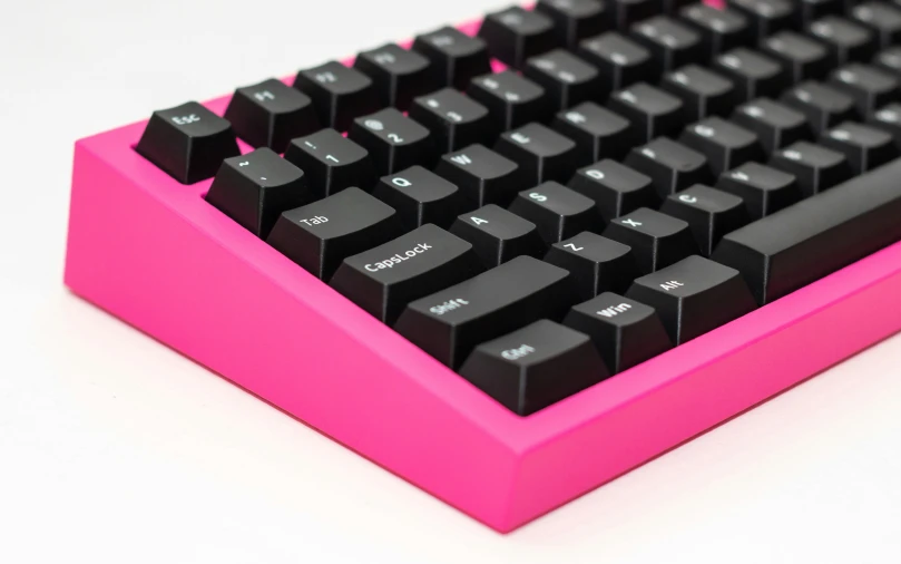 a black and pink keyboard with small numbers on it