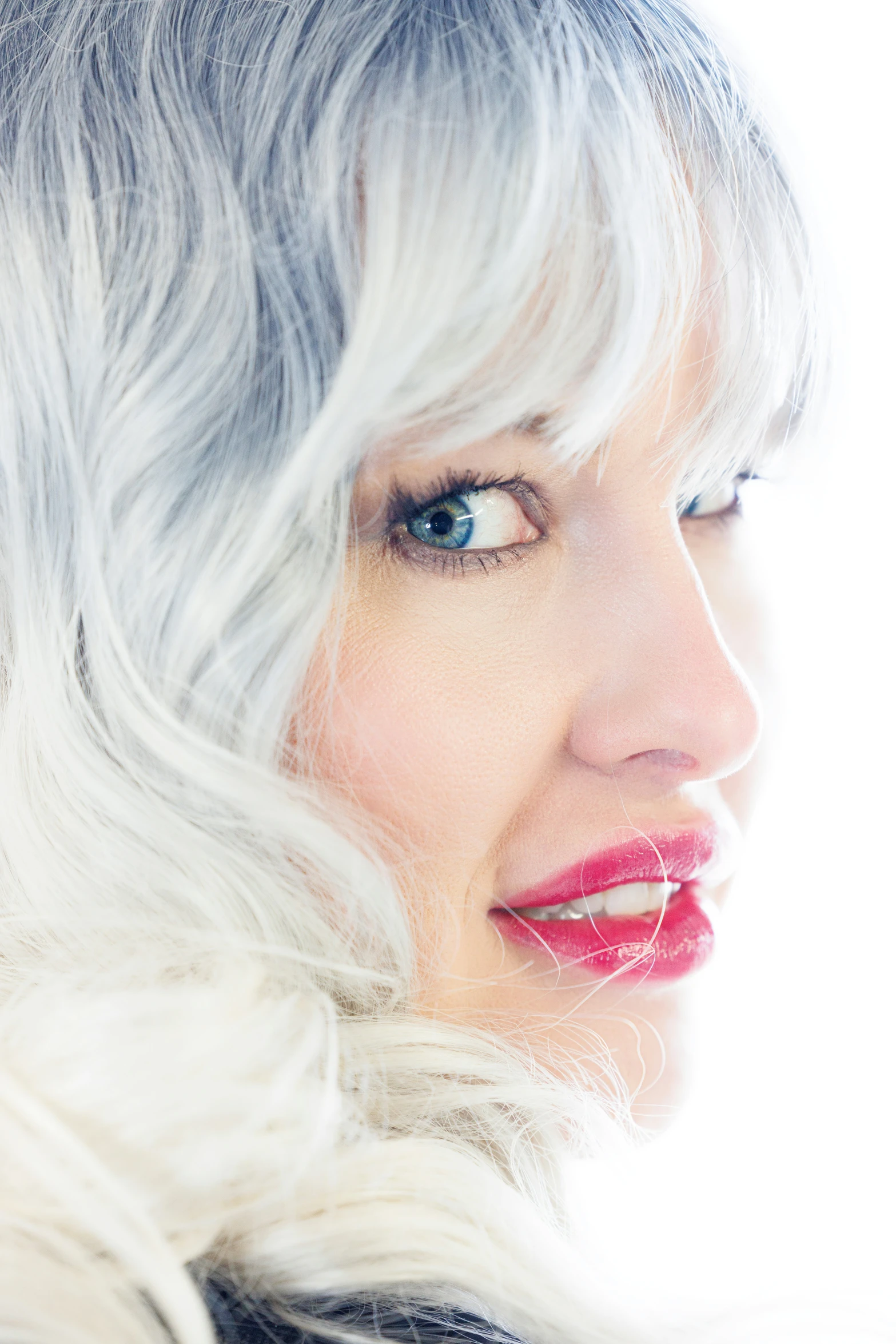 a woman with blonde hair and bright pink lipstick