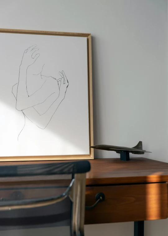 drawing of a woman sitting in the center of a room next to a desk