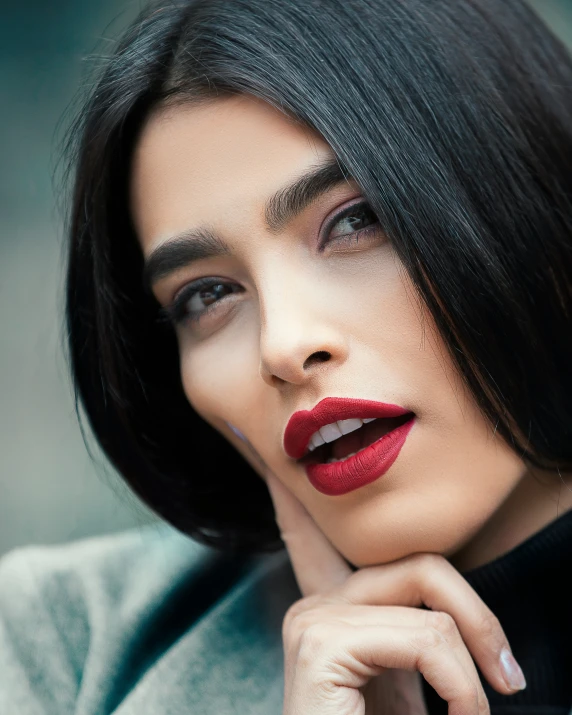 a close up of a person with a necklace and red lipstick