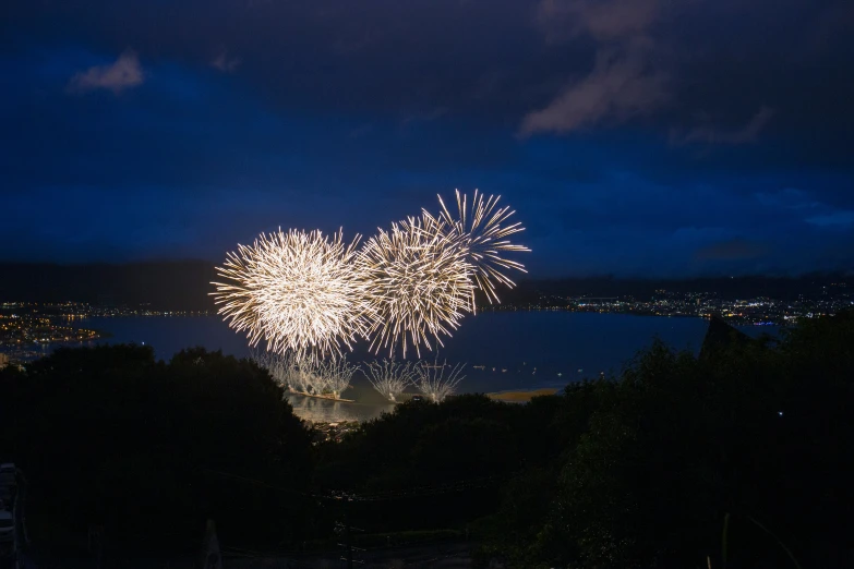 a fireworks display above the water at night