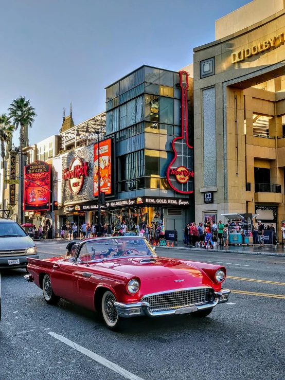 an old fashion car is traveling down the road