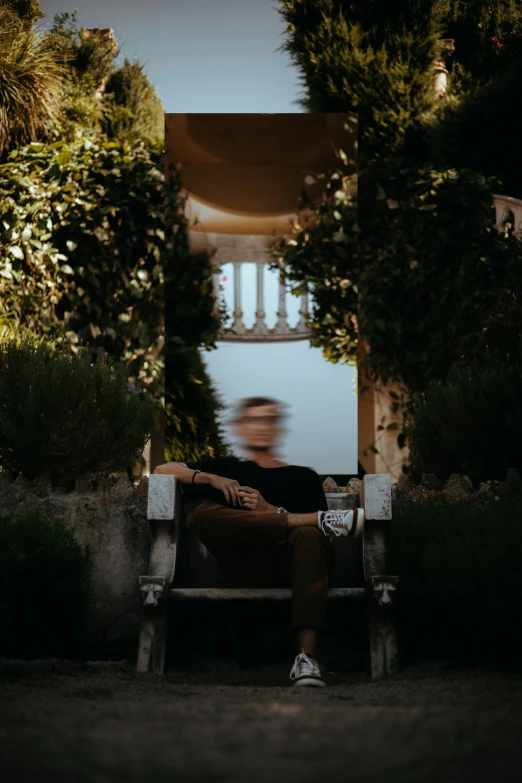 man sitting on a bench with a view of a building