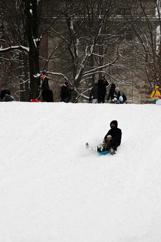 a person on a snowboard sitting down in the snow