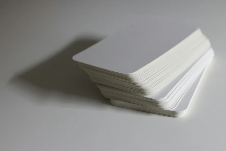 four stacked business cards on a white background