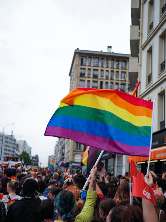 people in the street with a rainbow flag