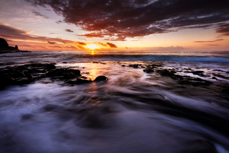 a view of the sun setting over the ocean